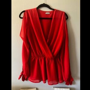Vibrant red polyester top with shoulder cutouts